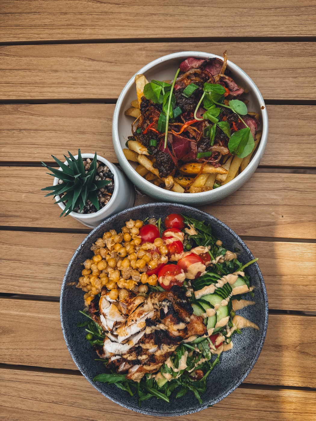 Loaded fries with bavette steak and a peri peri chicken salad